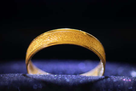 A closeup wedding ring on a blue backgroundの写真素材