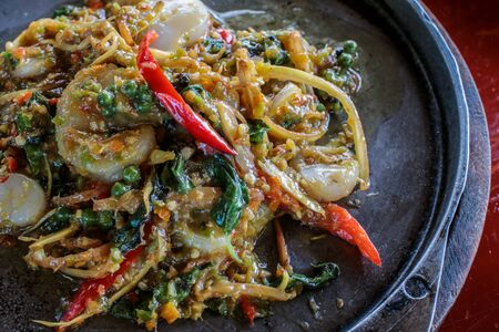 Spicy Seafood  stir fried (Pad Cha) on hot pan in restaurant, Thai Signature Foodの写真素材