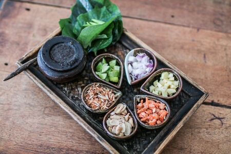 Thai Food Miang Kum Leaf-Wrapped Bite-Size Appetizer Leaf-Wrapped Bite-Size Appetizer. A Thai snack set of Wild Betel Leaf bush leave with ingredients chopped or cut into small piecesの写真素材