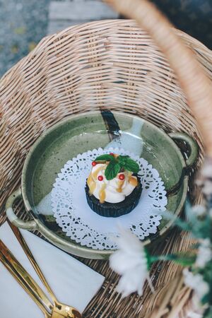 Homemade fresh pastries on a basket metal - cakes, cupcakes, cinnamon and brioches with spoon metalの写真素材