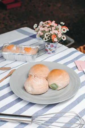 Close up various fresh baked buns/bread in market  with sweetened condensed milk, Thai tea custard...