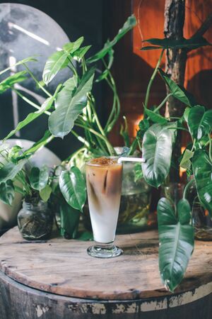refreshing iced coffees on wooden plate. with beautiful background,A cup of iced tea or iced coffee on a wooden table, refreshing and tranquil. Suitable for relaxing on holidays.の写真素材