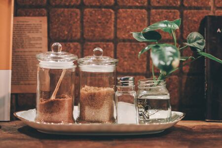 Brown sugar, White sugar in the bowl over wooden background for coffee fillingの写真素材