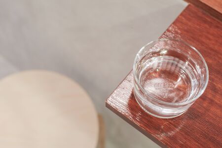 The bottle and clean glass of water on wooden background.selective focus, blur some part.の写真素材