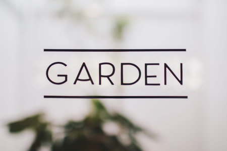 text  in front of mirror coffee shop written words garden with blurring background Minimalist...