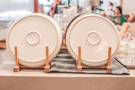 Ceramic plates dishes white Stacked  decoration in wooden shelf Bamboo Kitchen Dish Drying Rack with Plates and Mugsの写真素材
