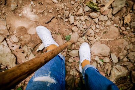 Bamboo hiking stick in hand of woman backpacker hiking in mountains alone outdoor active lifestyle travel adventure vacations hills landscapeの写真素材