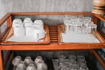 Piles of white clean plates, table knives, forks, spoons, napkins. Preparing for guest service in the restaurant buffetの写真素材