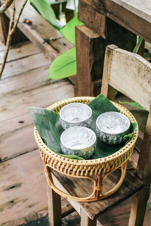 Metal water dipper,metal water bowl for drink on wooden table in restaurantの写真素材