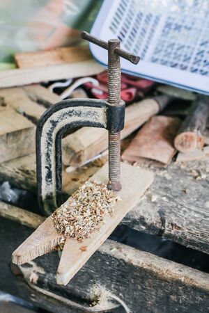 carpenter working with a wood product, hand tools, close up cutting wooden boards. Construction details of male worker or handy man with power toolsの写真素材