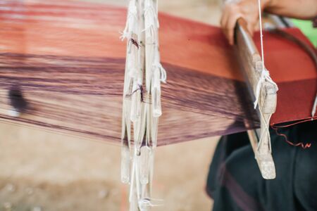 Weaving equipment Household weaving - Detail of weaving loom for homemade silk Used for silk weaving or textile production of Thailand Native cotton weaving using a Loom of weaving, which is folk wisdom, showing the ingenuity in creating Thai art.の写真素材