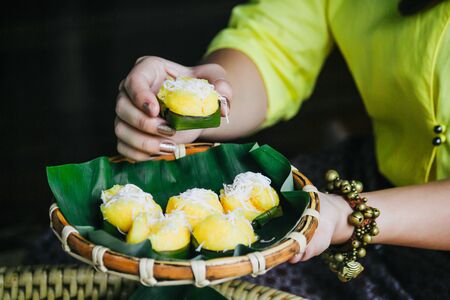 Toddy Palm cake (Kanom Tarn) Thai dessert and packaging from banana leaf with freshly grated coconut A local popular Thai dessert made from coconut milk, rice flour, yeast and toddy palms.の写真素材