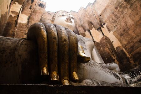 Ruins temple Sukhothai historical park, Thailand, the body to head part of the big buddha image at Wat Sri Chum in Sukhothai.の写真素材