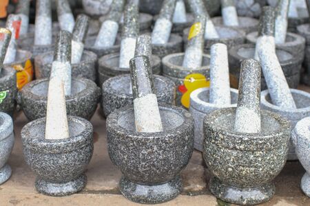 Stone mortars are Thai kitchenware.for thai food cooking. original thai kitchen utensil for pounding spice mixture.pounding spices like chilli, garlic, shallot, pepper, etcの写真素材