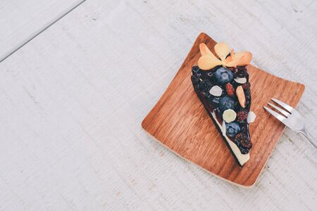 Homemade vanilla Black forest berry fruit cheesecake with fresh organic blueberries, berry sauce and mint for dessert. Sweet summer pastry,の写真素材