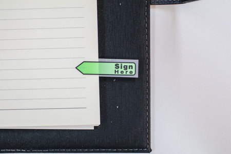 Text sign showing Sign here sticker on document on white paper Paper sheets pencil clips Plank...