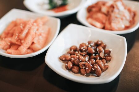 hand holding chopsticks for eating Kimchi salad in restaurant. Korean food traditional Kimchi.Korean food traditional cuisine. Fermented food. Vegetarian food good for health, Vegan for weight control dietの写真素材