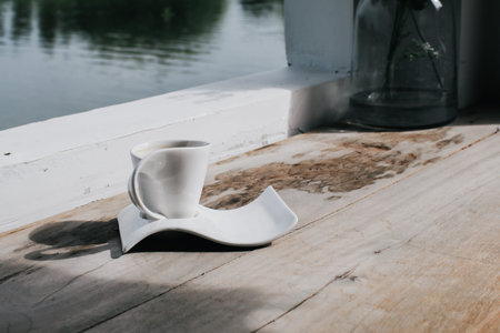 Cup of coffee on table in cafe ,Morning light over river landscape with sunlight. Beauty nature...