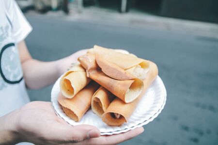 Thai traditional pancake with custard or egg call "Kanom tokyo", thai sweet pancake famous for street food that is cheap,thin flat pancake filled with pork or sausage. perfect dessert for everyoneの写真素材