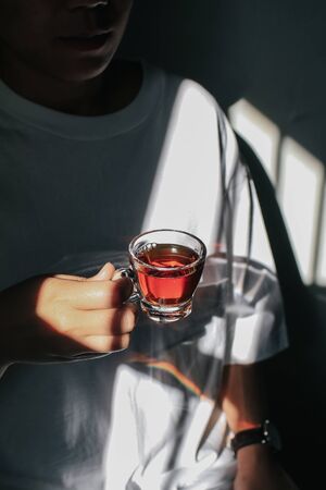 Close up man holding a cup of teaの写真素材