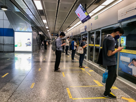 BANGKOK/THAILAND-May 27, 2020:  MRT subway train in Bangkok rolling out social distancing Infection control measures,significant reduction in passengers.Many people wearing mask are queuing.のeditorial素材