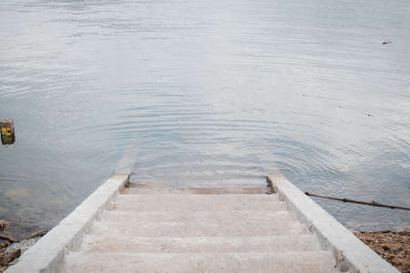The stairs or step ladder concrete of dam to reservoir Khun dan prakan chon dam have level measurement left side.の写真素材