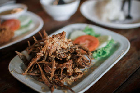 Thai crispy deep fried small fish with garlic and pepper.This would be served as a starter or tapas in local Thailand, Spicy Seafood Asian Dishの写真素材