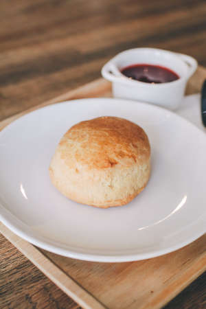 Close-up Homemade delicious English scone set with strawberry jam on the table. Horizontal,copy space for text, selective focus.の写真素材