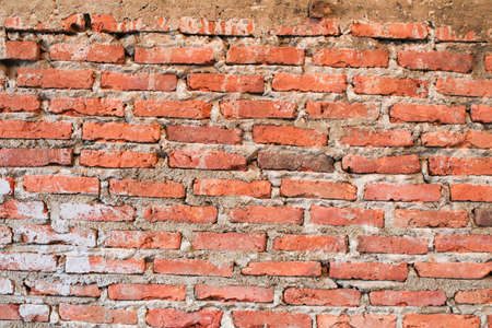 Urban background. red brick wall texture grunge stonewall Background. Shabby Building Facade With Damaged Plaster. Abstract Web Banner. Copy Space.の写真素材