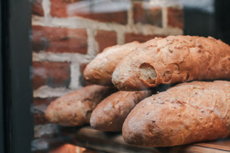Delicious Fresh baked baguette by a windowsill in a bakery with other breads. Photo bakery bread baguette in marketの写真素材