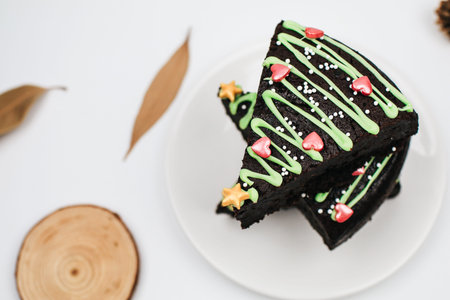 Fresh Homemade Chocolate Brownie  with green icing and festive sprinkles close up. Sweet homemade...