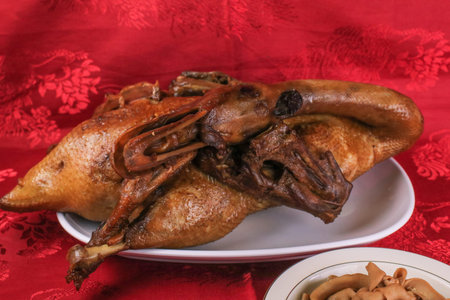 Delicious golden brown duck or steamed duck in Paloe or Lou mei Sauce (Thai name is Pedpalow) for Offering Sacrifices On Chinese New Year on red background.の写真素材