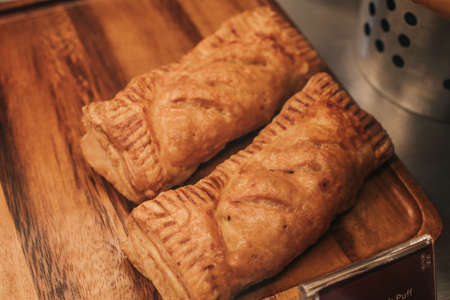 Puff pastry with toppings. Puffs with cheese on a wooden tray. Pastries and bakery, top view.の写真素材