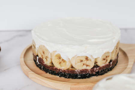 Banoffee cake with bananas, whipped cream, chocolate, caramel, coffee and toffee in cafe restaurantの写真素材