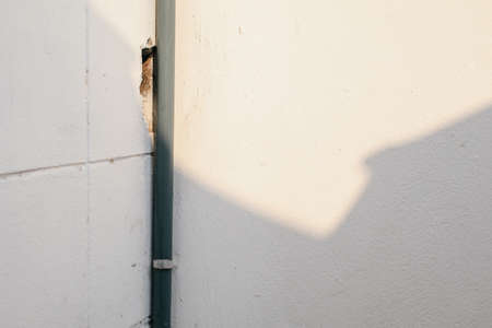 White cement wall with line of sun light and shadow at afternoon. used for template, background or texture.の写真素材