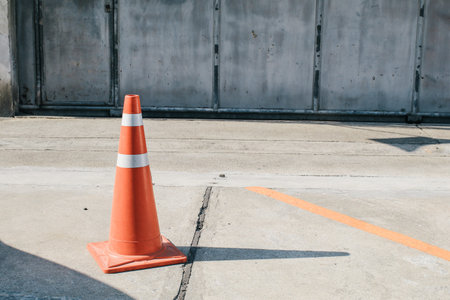 Traffic cone to mark road works or temporary obstruction. Orange traffic cone are placed to protect...