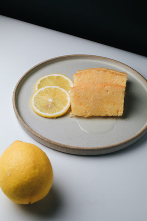 Lemon pound cake with slices of lemon sugar icing on black and white background. Delicious...