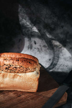 Fresh homemade Loaf of bread with truffle on cutting board. Bakery gold rustic crusty loaves of bread and buns.の写真素材
