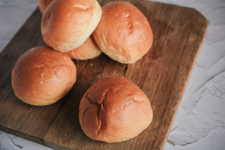 Freshly baked bread. Organic whole-wheat loaves on white background. Mini bread pile. Bakery bread...