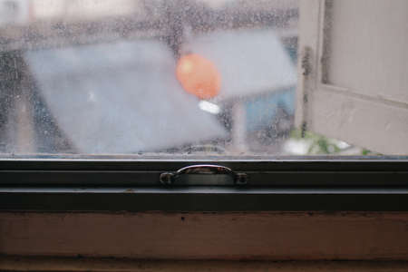Small raindrops on the window glass in the rainy season. Selective focus. Background concept.の写真素材