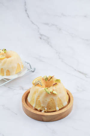 Lemon cake on marble table. Close up slice of citrus cake by classic recipe. Healthy nutrition, homemade vegan dessert.の写真素材