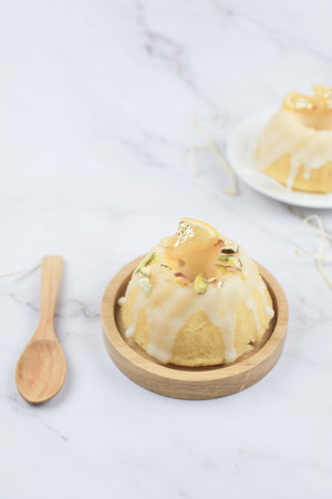 Lemon cake with sugar frosting on marble table. Healthy dessert. Delicious breakfast, traditional...