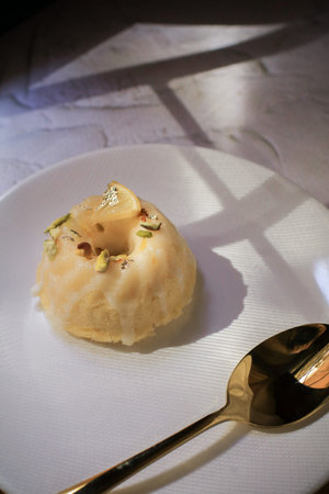 Lemon cake with yellow tulip, classic recipe, decorated with sugar icing in white ceramic plate on...