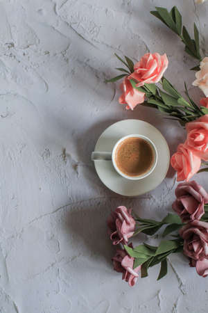 Coffee cup with rose flower on white table background. Valentine day with place for text. Vintage photo. Space for textの写真素材