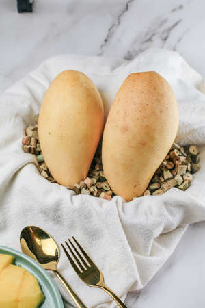 Fresh yellow Mango on white background. Tropical summer concept. Top view, close up, macro, copy space.の写真素材