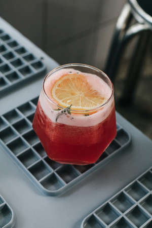 Mocktail of fresh pink lemonade with rosemary and orange. Festive drink is ideal for brunch, parties and holidays.の写真素材