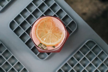 Mocktail of fresh pink lemonade with rosemary and orange. Festive drink is ideal for brunch, parties and holidays.の写真素材