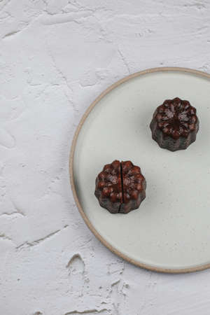 Caneles de bordeaux - traditional French sweet dessert. Rum and Vanilla Flavors with a Tender Custard Center and a Thick Caramelized Crust.の写真素材