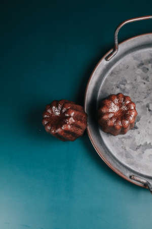 Caneles vanilla dark rum flavor traditional French sweet dessert with dark background. French Pastryの写真素材