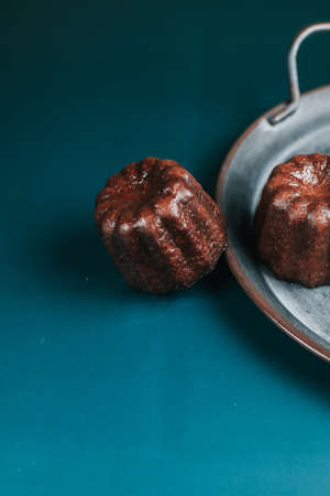 Caneles vanilla dark rum flavor traditional French sweet dessert with dark background. French Pastryの写真素材